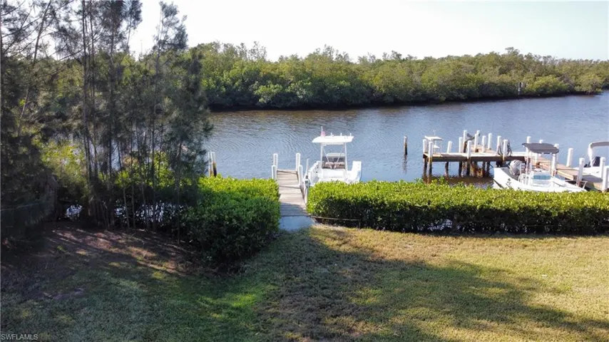 Dock area featuring a yard and a water view