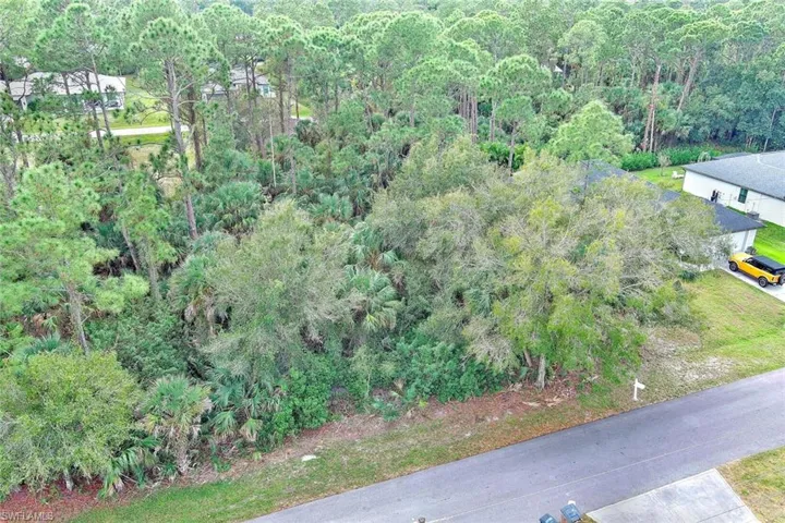 Aerial overview of property's location with a heavily wooded area