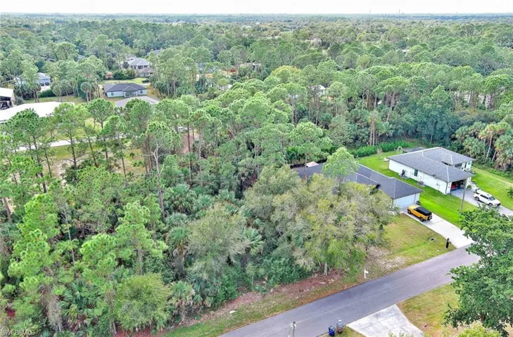 Aerial overview of property's location featuring a heavily wooded area