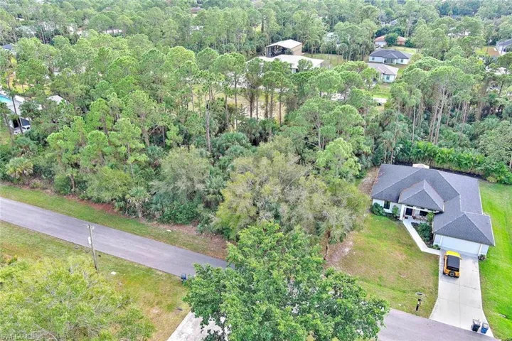 Aerial view of property's location with a forest