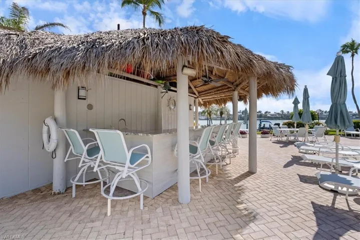 View of patio / terrace with a bar and a water view