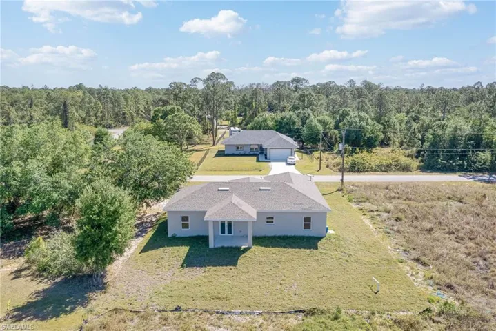 Drone / aerial view with a wooded view