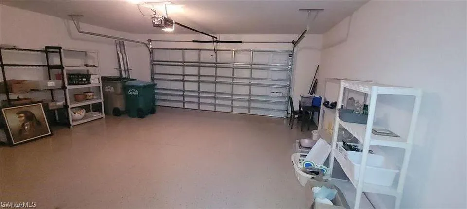 Garage featuring a garage door opener