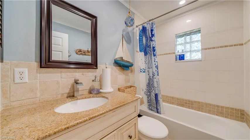 Guest bathroom with solid surface counter and updated cabinet.