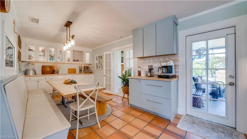 Dining area with coffee station and lots of extra cabinets including a wine rack.