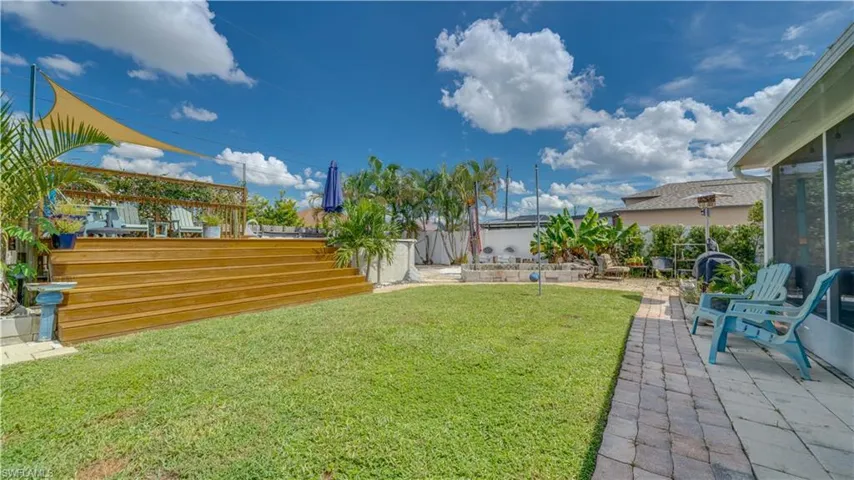 Back yard with an above ground pool and a custom built deck.