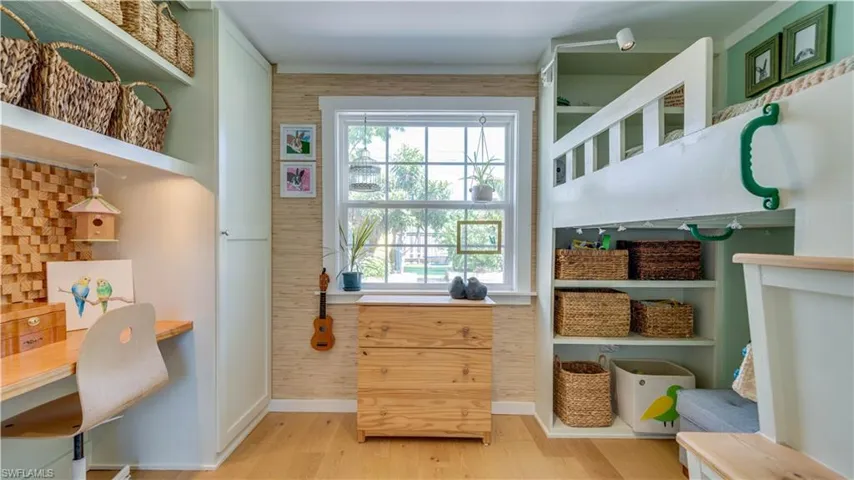Guest bedroom with built-in bunk bed (included with sale), laminate flooring, extra shelving and closet.