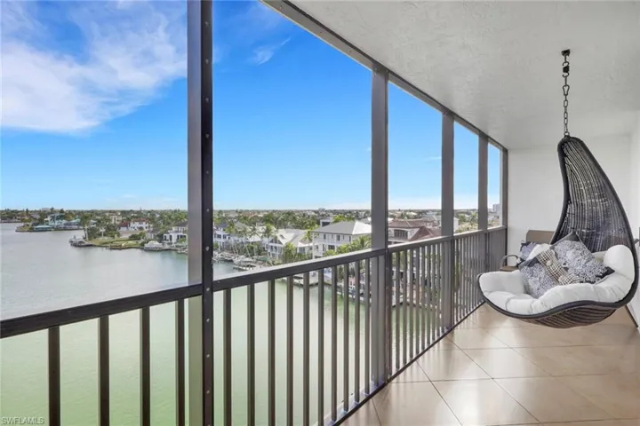 Sunroom featuring a water view