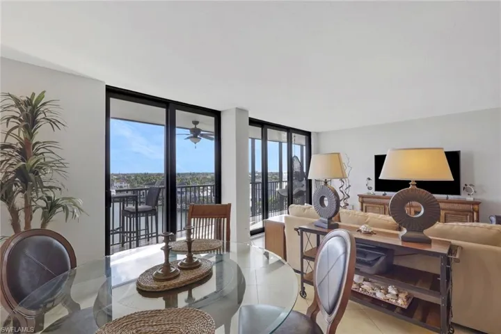 Dining room featuring floor to ceiling windows and light tile patterned floors