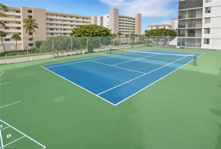 View of tennis court with community basketball court