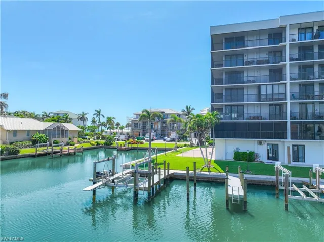 Water view featuring boat lift and a dock