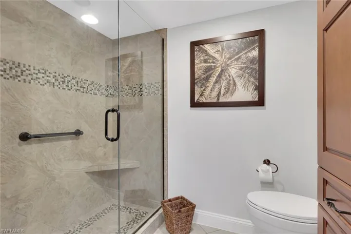 Full bath featuring a stall shower and light tile patterned floors