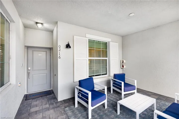 Entrance to property with stucco siding