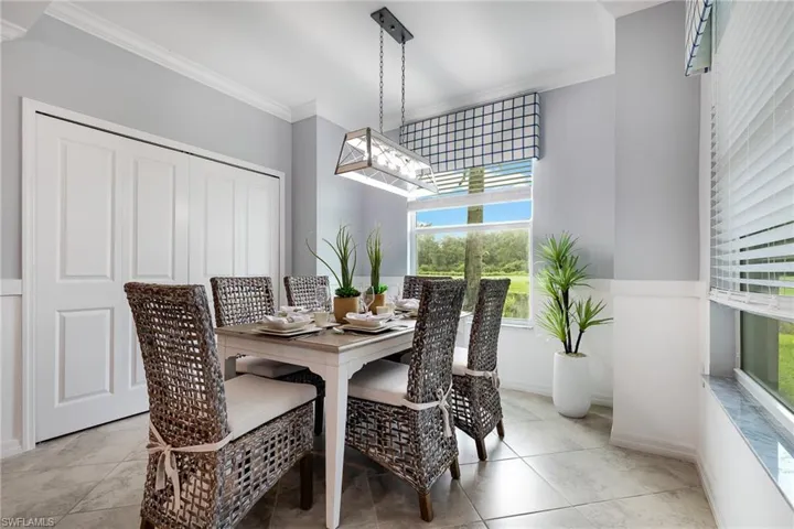 Dining area with baseboards and crown molding