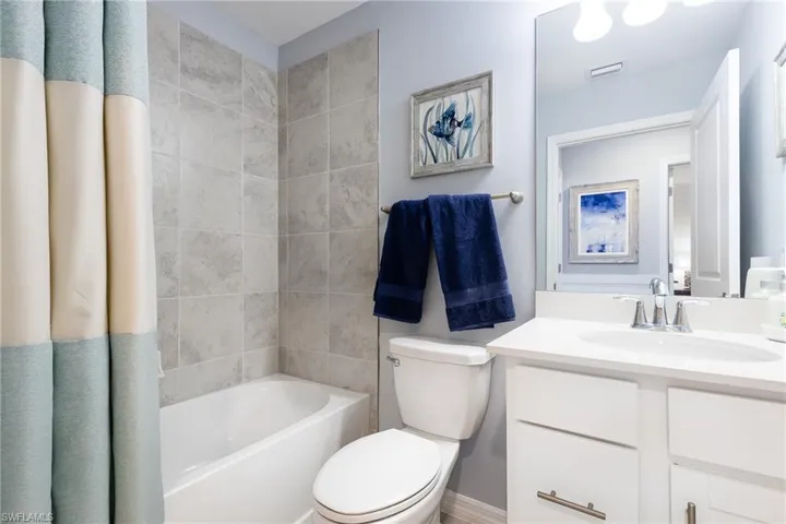 Full bathroom featuring vanity and shower / bath combo with shower curtain