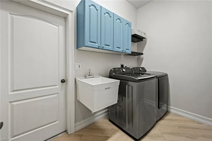 Laundry area featuring washer and dryer and cabinet space