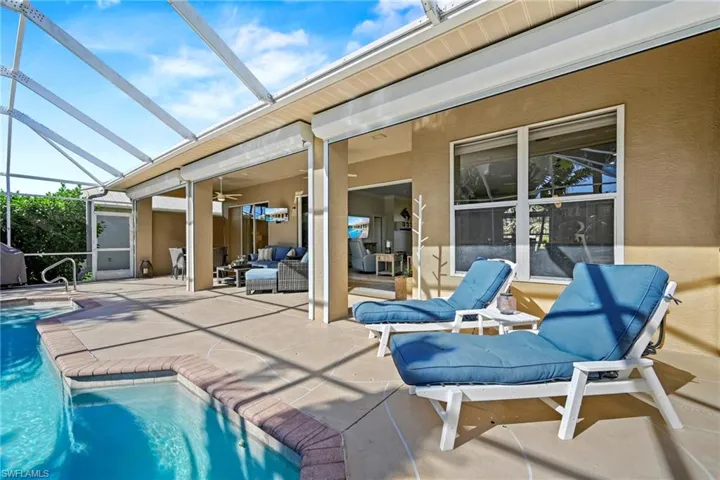 Swimming pool featuring a sunroom, a lanai, a patio, and outdoor lounge area