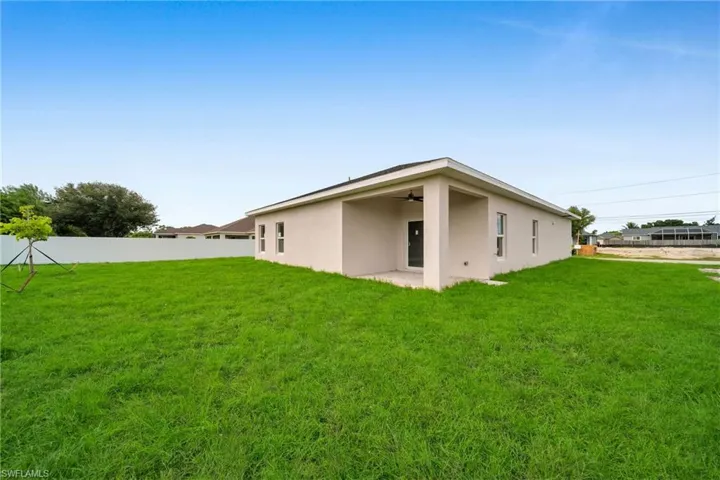 Rear view of property featuring a lawn