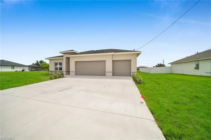 Prairie-style home with a front yard and a garage