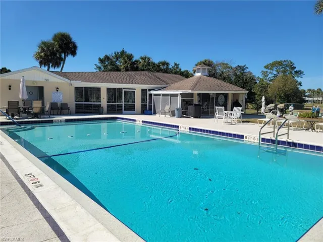Community pool with a patio