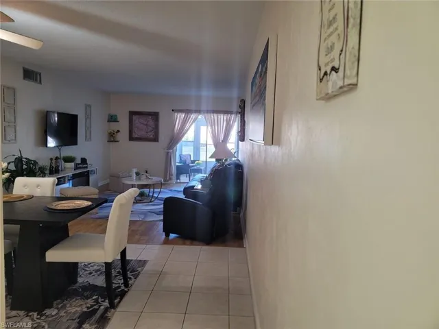 Dining area featuring light tile patterned floors and a ceiling fan