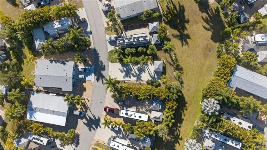 Aerial view of property and surrounding area featuring nearby suburban area