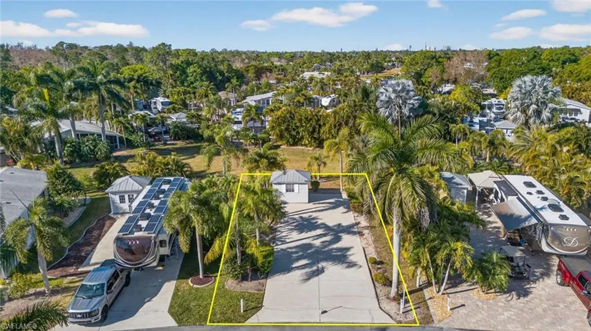 View of property location with property parcel outlined and a tree filled landscape