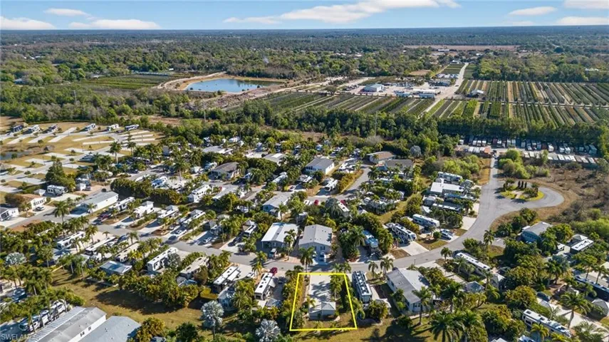 Aerial overview of property's location with nearby suburban area and a large body of water