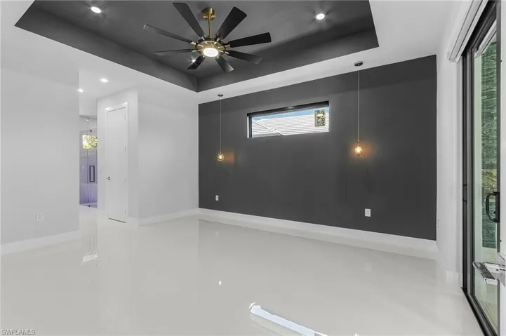 Empty room with recessed lighting, baseboards, a raised ceiling, and a ceiling fan