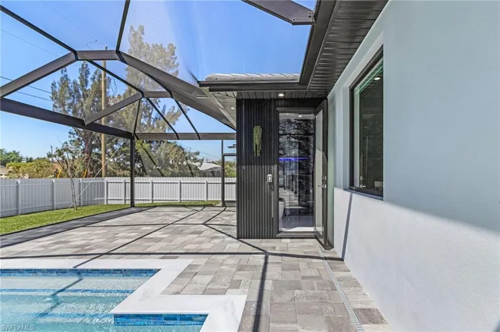 View of swimming pool with a patio, fence, a fenced in pool, and a lanai