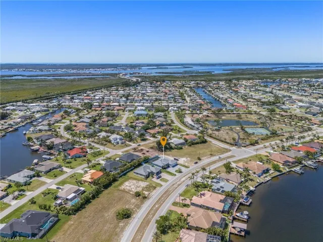Birds eye view of property featuring a water view and a residential view