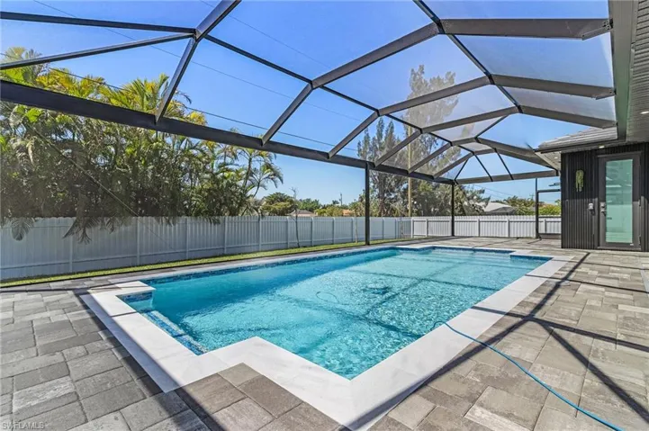 View of pool featuring a lanai, a fenced in pool, a patio, and a fenced backyard