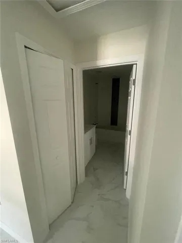 Hallway with light tile floors