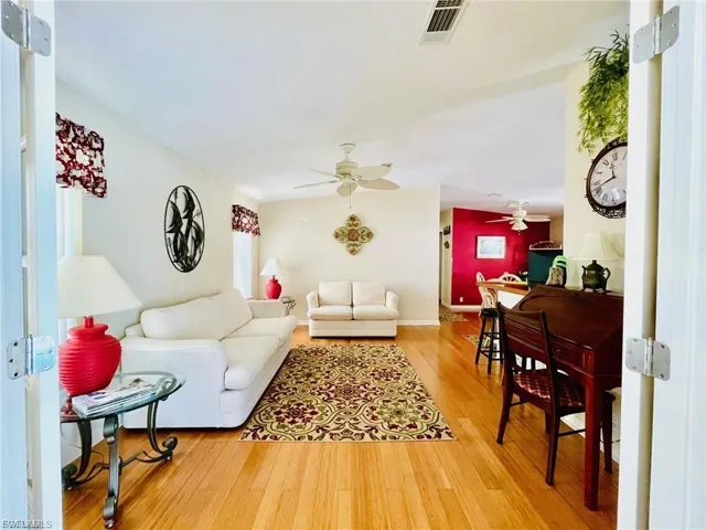 Living area featuring light wood-style flooring and ceiling fan