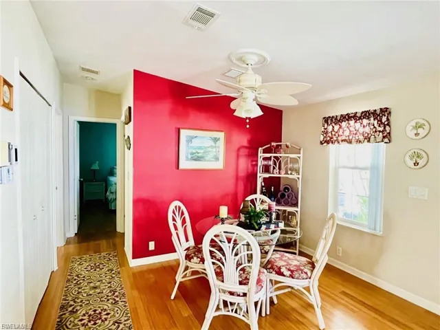 Dining space featuring wood finished floors and a ceiling fan