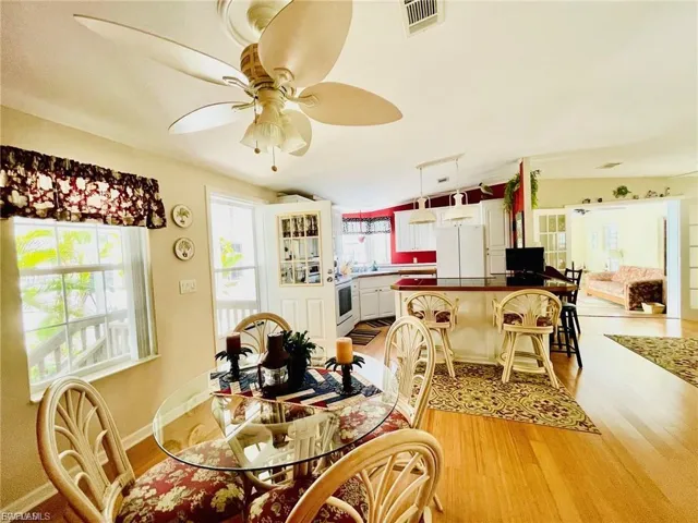 Dining space featuring light wood-type flooring and a ceiling fan