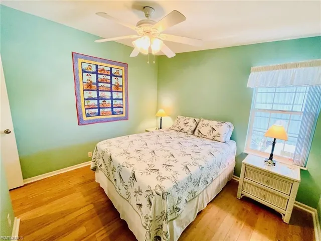 Bedroom featuring wood finished floors and a ceiling fan