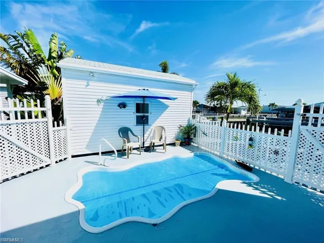 View of pool with a pool, a wooden deck, and an outdoor structure