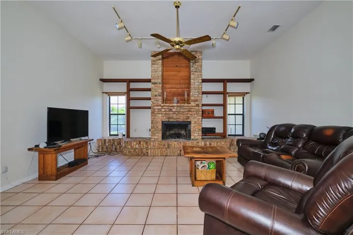 Spacious den with wood burning fire place.