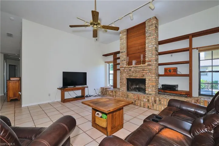 Spacious den with wood-burning fire place.