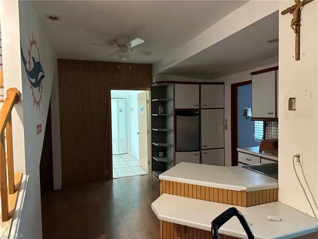 Downstairs Kitchen featuring hardwood / wood-style flooring, fridge, kitchen peninsula, and ceiling fan