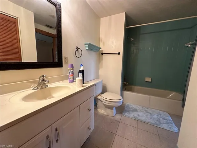 Full bathroom featuring tile patterned floors, vanity, shower / bathing tub combination, and toilet