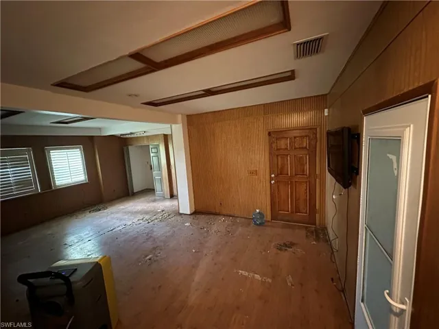 Downstairs living room featuring wood-type flooring and wood walls