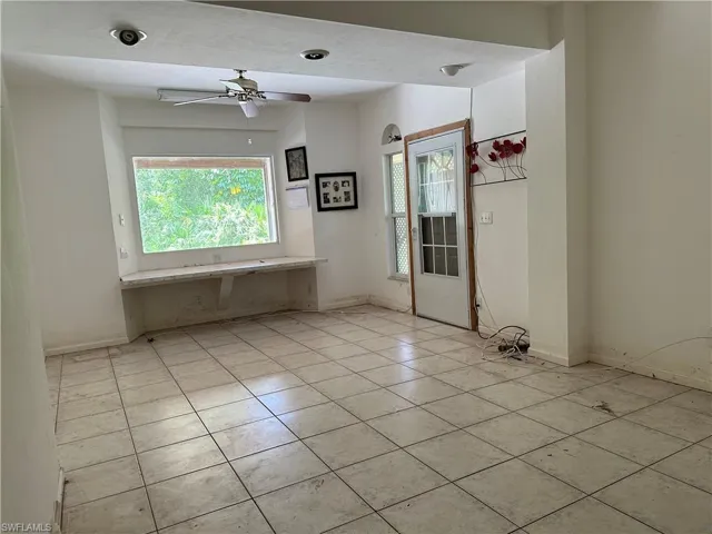 Den, Office, Additional room downstairs, Tiled spare room featuring ceiling fan