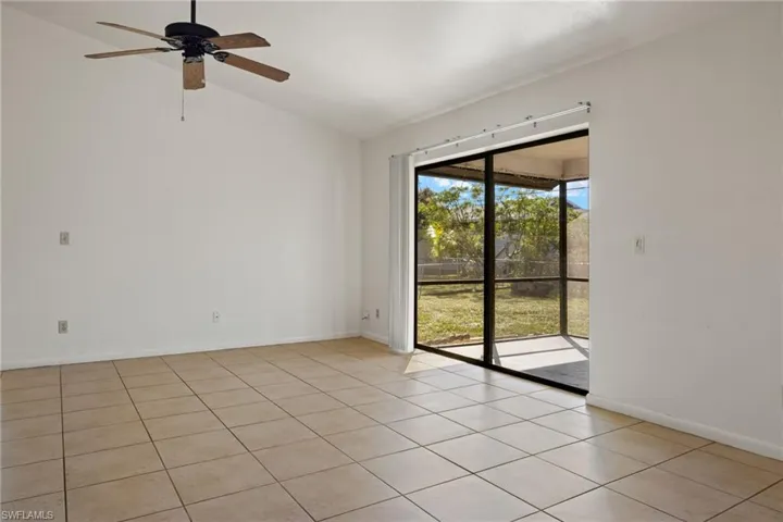 Empty room with ceiling fan and vaulted ceiling