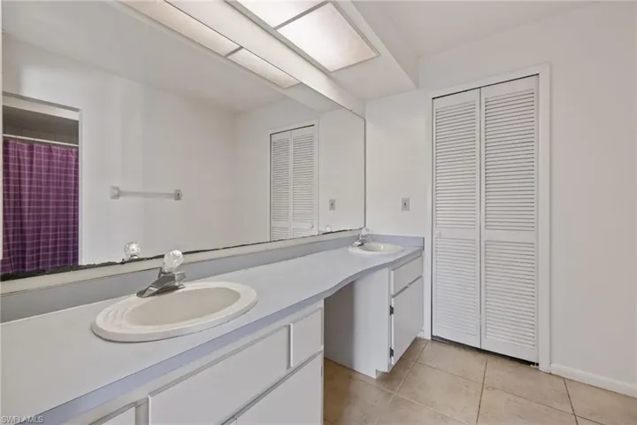 Bathroom with tile patterned floors and vanity