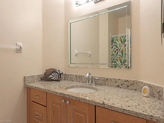 Full guest bathroom featuring vanity and shower