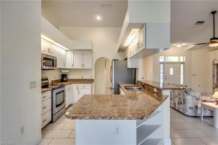 Granite countertops & stainless appliances & plenty of cabinets in the kitchen.