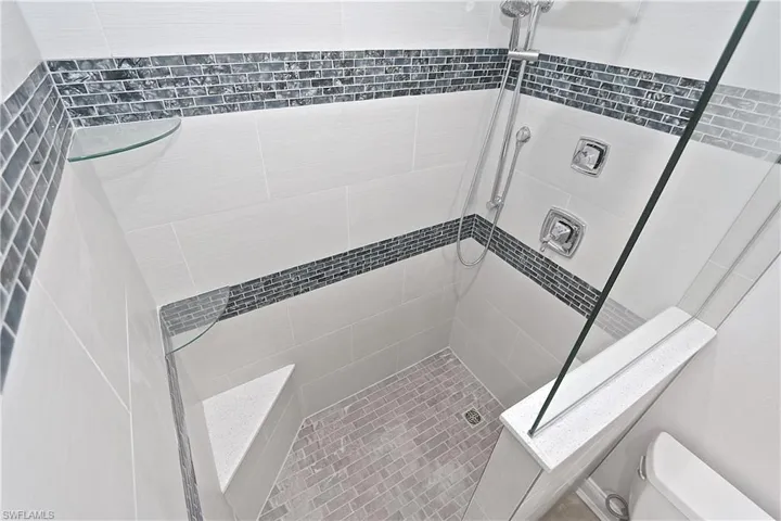 Bathroom with a tile shower and toilet
