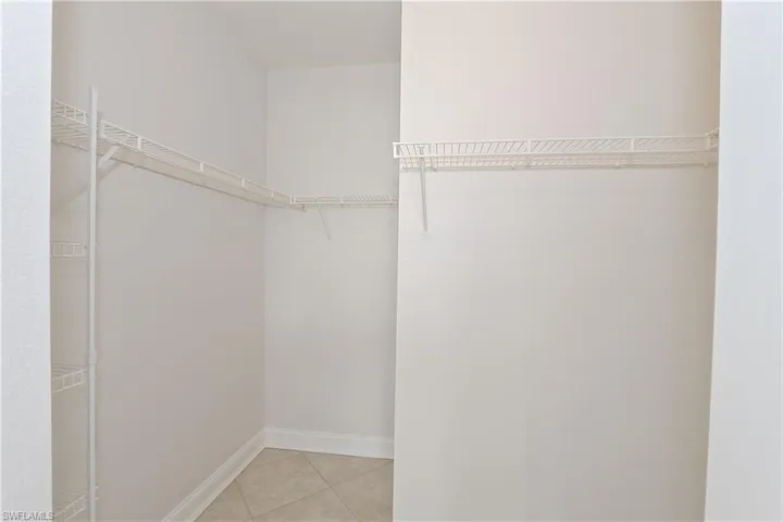 Walk in closet with light tile patterned floors